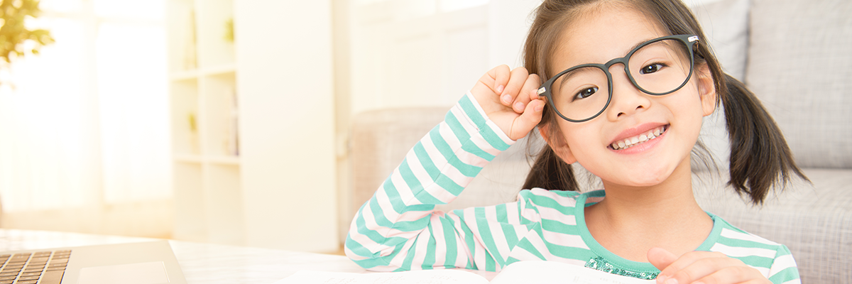 Young boy with glasses smiling