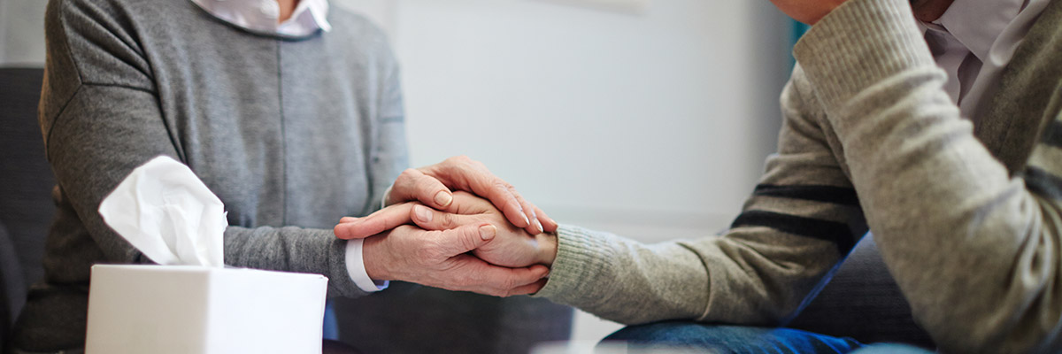 Counselor holding a patients hand