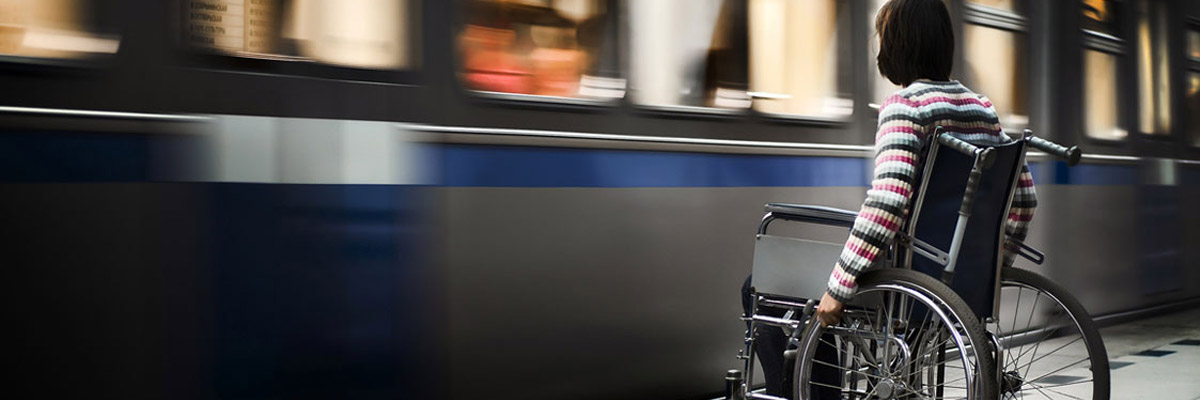 Person in wheelchair waiting for a train