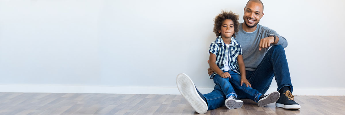 Father and son sitting on floor